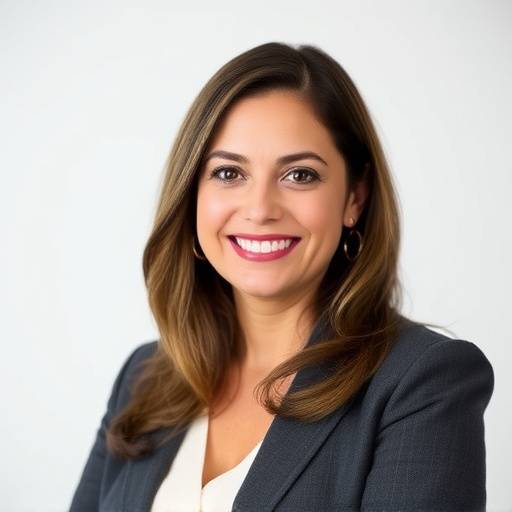 A portrait of Elena Rodriguez, the Executive Director of Aurora Arts Collective.